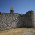 Hrastovlje Holy Trinity Church entrance wall