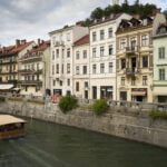 A boat sailing the Ljubljanica and a few of facades