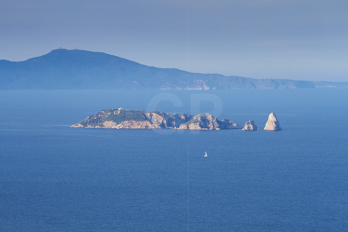 Sailing between Begur and Medes Islands with Montgrí Massif in background