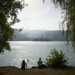 Lake Bled island framed with leaves and branches