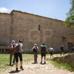 A group of hikers walking to Santa María Church in Siurana