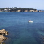 A boat floating before S'Agaró beach