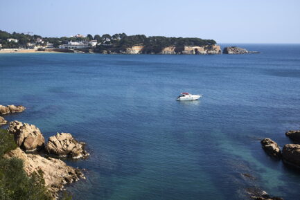 A boat floating before S'Agaró beach