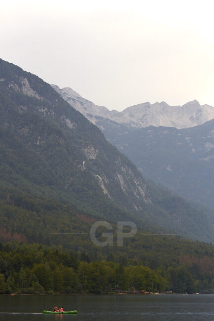 A couple rowing a Kayak inside Bohinj lake