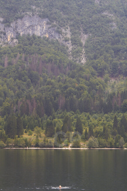 A girl swimming inside lake Bohinj
