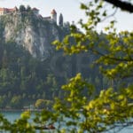 Stunning Landscape Photo of Bled Castle and Lake – Framed by Nature from Bled Village