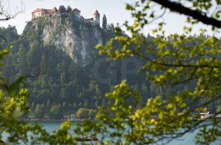 Stunning Landscape Photo of Bled Castle and Lake – Framed by Nature from Bled Village