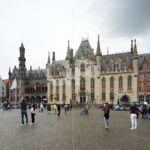 Front view photograph of the Bruges City Hall Gothic façade on the Burg square