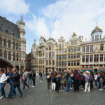 Horizontal photograph of the Maison du Roi d’Espagne with people in Brussels’ Grand Place